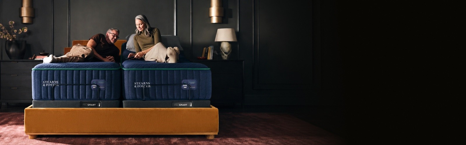 couple sitting on a split king Reserve with an adjustable base lifting the head of one side