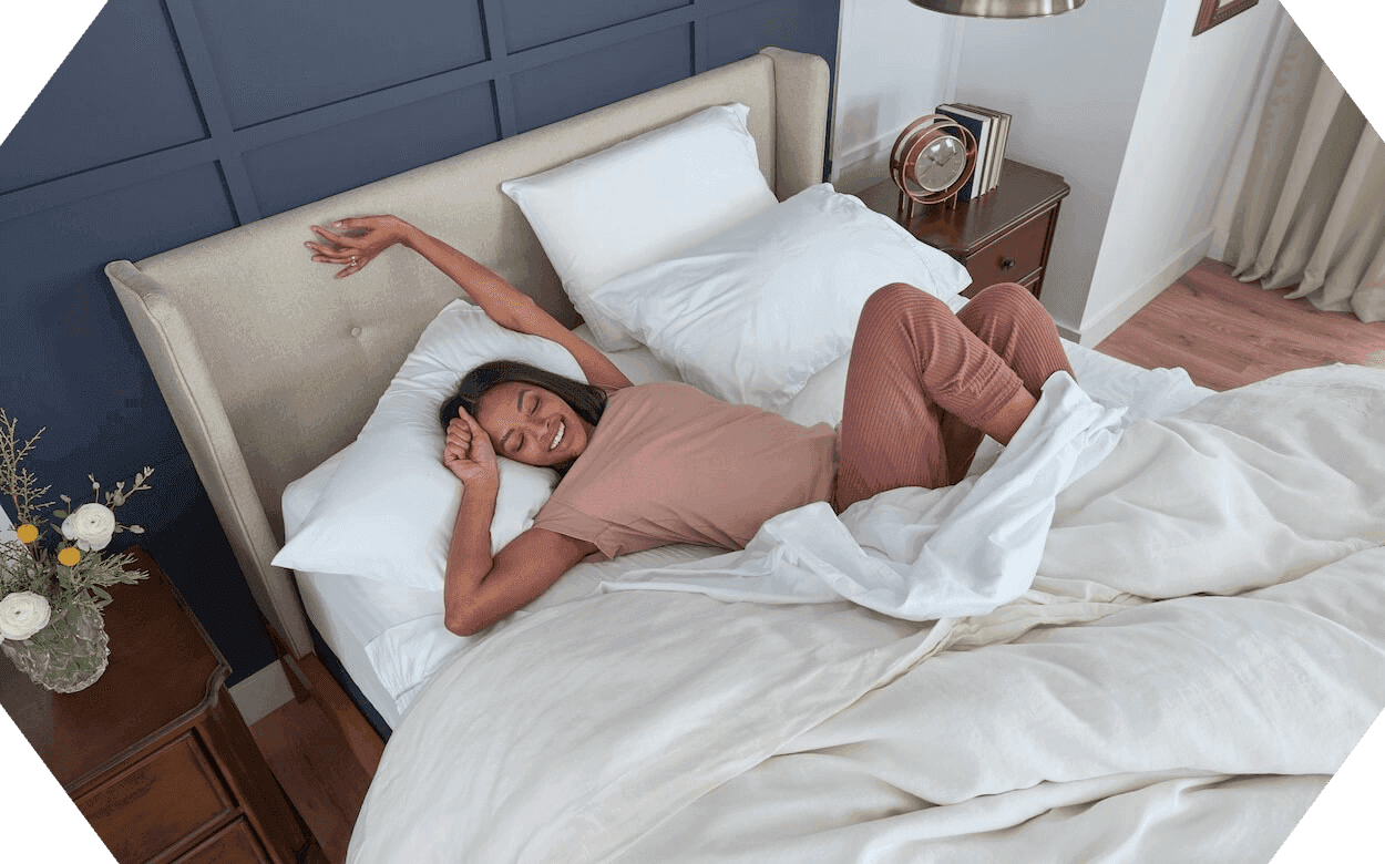 A woman laying on a mattress