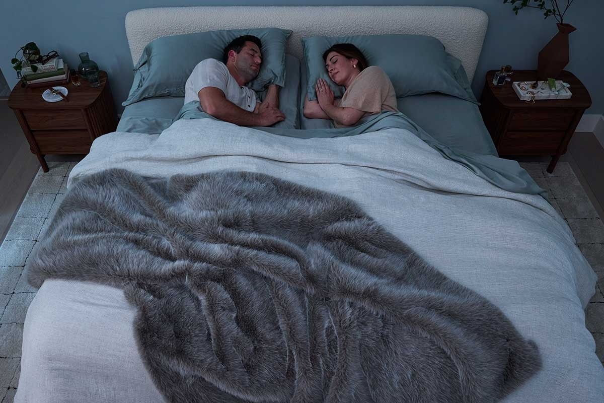 A couple sleeping in a styled room