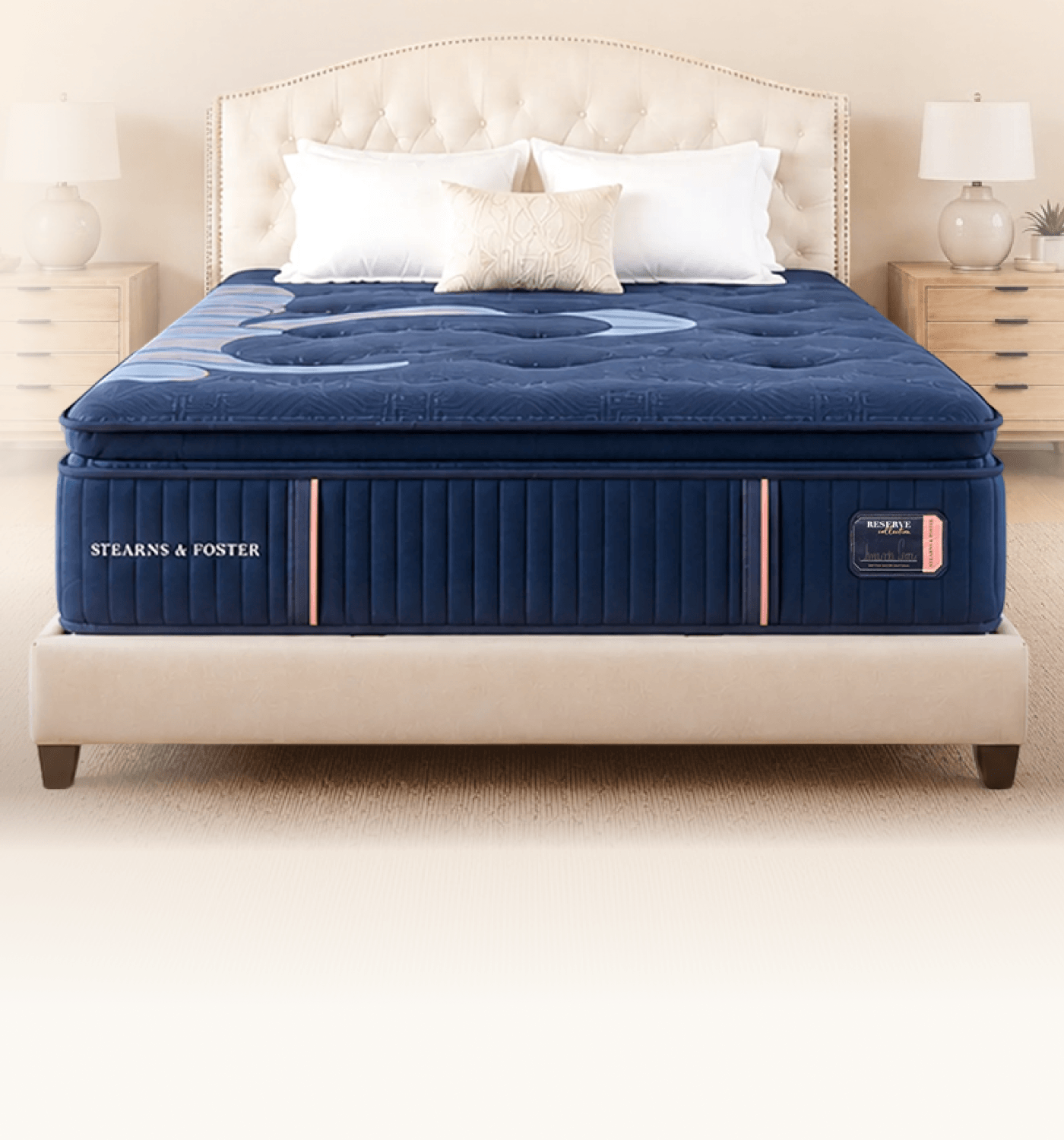 a bare reserve mattress with some pillows against the headboard