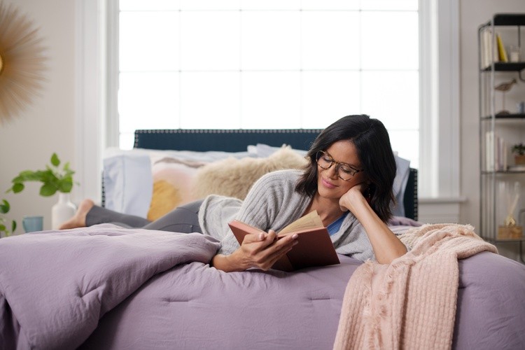 women laying on Estate mattress reading.jpg